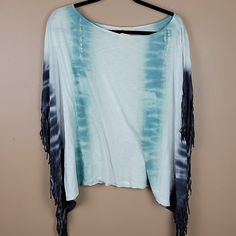 Has An Arm Hole. White Blue And Navy Tie Dye. New With Tags. Lightweight. Summer Poncho With Fringe, Summer Long Sleeve Poncho With Fringe, Blue Fringe Top For Spring, Blue One-size Poncho With Fringe, Blue Fringe Poncho One Size, One Size Blue Poncho With Fringe, Blue Fringe Tops For Summer, Oversized Blue Bohemian Top, Blue Casual Poncho For Vacation