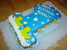 a blue birthday cake with rubber ducks on it