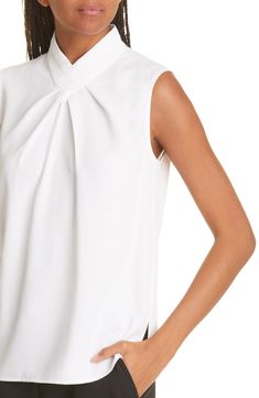 A pleated crossover collar lends sophisticated drape to a sleeveless crepe blouse for a refined workday look. Stand collar V-neck Sleeveless 100% polyester Hand wash, line dry Imported Elegant Draped White Blouse, Elegant White Draped Blouse, Elegant Sleeveless Viscose Blouse, Elegant Sleeveless Viscose Top, Elegant Sleeveless Tops For Office, Elegant Draped Tops, Elegant Draped Formal Tops, Elegant Draped Blouse For Workwear, Elegant Draped Top For Workwear