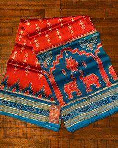 two red and blue sari with elephants on them