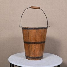 a wooden bucket sitting on top of a table