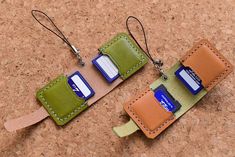 two small wallets are hanging on the cork