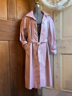 "Vintage 1980s British Mist pink trench coat, raincoat. This pearlized dusty pink trench coat style raincoat by British Mist features pleating on the front and back, 2 side pockets, and 5 front button and tie at the waist closure.  Really good con; no flaws. Maker label reads British Mist Size 8P; see measurements below: Measurements: Chest: 23\" Length: 43\" Sleeve outseam: 22\" Sleeve inseam: 15.5\" All the items I list in my store are vintage or antique. Some treasures will show signs of wear Pink Raincoat For Fall Rainy Weather, Pink Fall Raincoat For Rainy Weather, Vintage Pink Outerwear With Pockets, Vintage Pink Spring Outerwear, Pink Trench Coat, Trench Coat Style, Coat Style, People Sitting, Dusty Pink