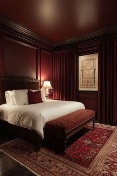 a large bed in a room with red walls