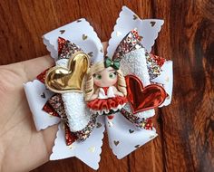 This super cute hair bow is made grosgrain ribbon and glitter faux leather. In the center is a doll made of polymer clay.It measures approximately 4.5 inches and is attached to alligator clip 2.3 inch. Clay Doll, Felt Bows, Glitter Hair, Easter Hair, Clay Dolls, Diy Hair Bows, Girl Hair Bows, Doll Hair