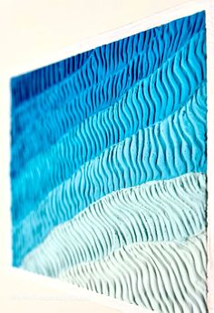 a blue and white abstract painting with wavy lines