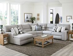 a living room filled with furniture and lots of windows