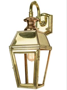 an old fashioned brass wall light on a white background