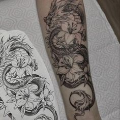 a dragon and flower tattoo on the left arm, next to a drawing of a snake