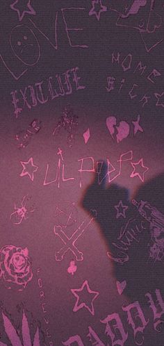 someone is writing on the wall with pink light and black shadow in front of them