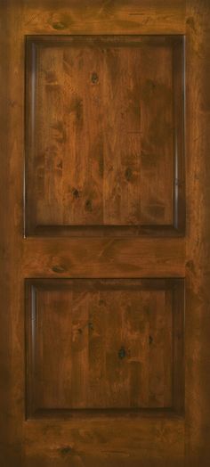 a close up of a wooden door with two square panes on the top and bottom