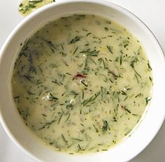 a white bowl filled with soup on top of a table