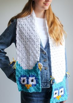 a woman is wearing an owl vest made from crocheted yarn and has her hands on her hips