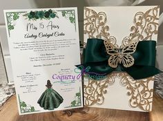 a green and white wedding card with a butterfly on it's back, next to a matching brochure