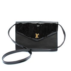 Vintage Paloma Picasso black leather envelope bag. Made in Italy. Contrasting patent leather on triangle flap and shoulder strap with smooth grain leather on the rectangle shaped body. Magnetic snap closure. Strap is adjustable with snap buttons to be worn as a shoulder bag or crossbody, or can be removed to be carried as a clutch. Plaque, tag and original card / price tag included inside. This bag is very rare and highly collectible. 10” x 7.25” with 18” strap. Excellent vintage condition. Patent Leather Bag, Leather Envelope, Paloma Picasso, Black Crossbody Purse, Bags Vintage, Black Leather Purse, Envelope Bag, Leather Bucket Bag, Original Card