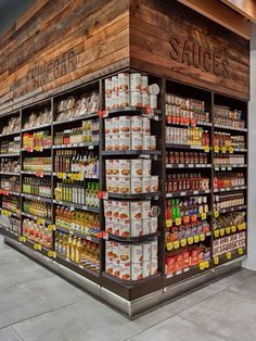 the inside of a grocery store filled with lots of food and drink bottles on display