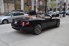 a black sports car is parked on the street