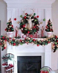 a mantel decorated with christmas decorations and deer heads