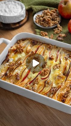 a casserole dish with apples and nuts on the side