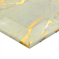 a marble table top with yellow and white paint on the edges, against a white background