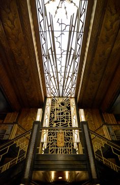 the inside of an ornate building with metal railings and decorative ironwork on the ceiling