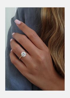 a woman's hand with a diamond ring on it