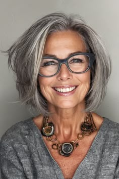 For women over 60 with glasses, the salt-and-pepper layered bob reigns supreme as a timeless choice. Click here to check out more elegant hairstyles prove that glasses are the ultimate accessory for women over 60. Haircuts Low Maintenance, Short Hairstyles Pixie, Short Shoulder Length Hair, Flattering Bangs, Knitted Kimono, Medium Haircuts With Bangs, Grey Hair And Glasses, Layered Shag, Medium Length Blonde Hair