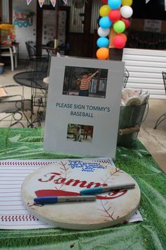 a sign that is on top of a table with a ball and pen in it