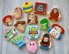 decorated cookies are arranged in the shape of toy story characters on a white table top