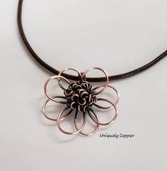 This gorgeous copper flower necklace is a perfect gift for your 7th Anniversary, Copper Anniversary, 22nd Anniversary, or as a gift for that special women in your life! The copper flower has been hand shaped, hammered, and wire wrapped to create the beautiful center of this copper pendant. It measures approximately 2 inches wide and 2 inches long. It has been antiqued and polished to a beautiful shine and is clear coated to protect the antique finish. It comes with your choice of either a black, 22nd Anniversary, Copper Anniversary Gifts, Copper Gifts, Copper Anniversary, Copper Cuff Bracelet, 7th Anniversary, Leather Corded Necklace, Copper Cuff, Flower Pendant Necklace