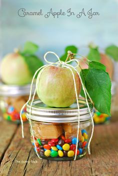 an apple in a jar filled with candy