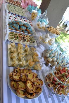 a table topped with lots of desserts and pastries