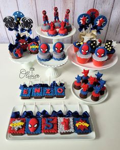 spiderman themed cupcakes and cookies are on display