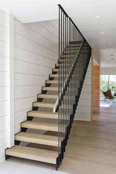 there is a set of stairs in the house that has wood treads on it