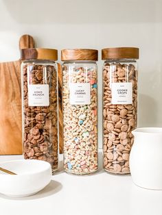 three jars filled with different types of cereal