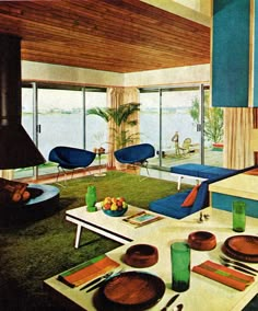 an image of a living room setting with blue chairs and green rugs on the floor