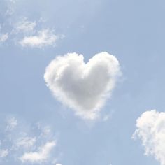 a heart shaped cloud floating in the sky