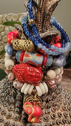 "\"Radiate boundless love towards the entire world.\" Buddah.  This handmade choice of 6 Stretch Bracelets are sure to bring you Peace, Serenity and Harmony. Wear alone or stacked, featuring:  1. Blue Sponge Coral with an African Krobo Millefiori Vintage glass focal bead in hues of washed denim blue  2. Red Peruvian Coral with African Brass focal bead  3. Smooth brilliant River Rock with a Coral Tahitian Buddah 30x20x20mm focal bead 4. Faceted Red Agate with horn spacers, pressed Czech glass Elephant charm in Scarlet Red with Gold Wash and an Ethiopian Labyrinth brass disk pendant 5. Set of two bracelets 4mm Natural Kyanite and light blue Jade. If  you would like to order the set, please message me...I can offer a 10% discount. Note: Bracelets are S-M each measure approx. 5.5\"-7\" around African Beaded Bracelets, Sponge Coral, Earthy Jewelry, Elephant Charm, Gold Wash, River Rock, Elastic Bracelet, Focal Bead, Gemstone Bracelets