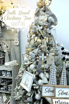 a white christmas tree with gold and silver ornaments on it, surrounded by other holiday decorations