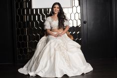 Diana is the perfect pick for the bride who wants a white wedding with a desi touch. Diana features a white lehenga with pearls, diamonds, and a touch of gold beadwork. The blouse has fun ruffled sleeves and a deep V back. Complete the look with its delicate dupatta. DELIVERY TIMEPlease allow 4-6 months for your outfit to arrive. FABRIC DETAILSRaw Silk. Professional cleaning only. Festive Ruffled Lehenga For Wedding, White Wedding Gown With Mirror Work, Wedding White Embellished Sharara, Wedding Embellished White Sharara, Anarkali Lehenga With Ruffles For Wedding, White Wedding Choli With Pearl Embroidery, White Choli With Pearl Embroidery For Wedding, Elegant White Lehenga With Mirror Work, Wedding White Pearl Embroidered Sharara