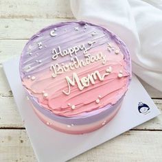 a pink and purple cake with the words happy birthday mom on it