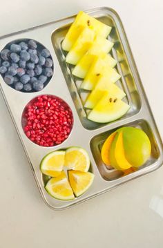 a metal tray filled with fruits and vegetables