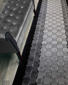 two gray couches sitting next to each other on top of a carpeted floor