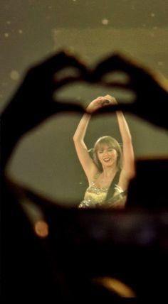 a woman is seen through a hole in the wall with her hand up to her head