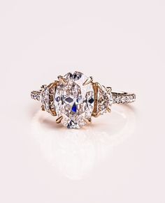 an oval cut diamond ring with three side stones