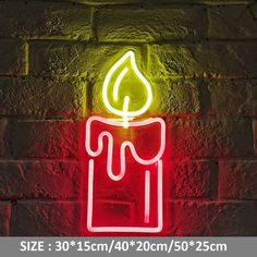 a neon lit candle sitting on top of a brick wall