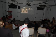 a group of people sitting and standing in a room