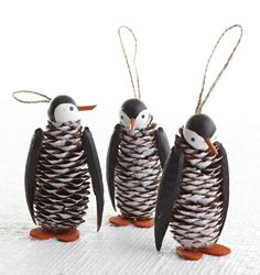 three penguins made out of pine cones are standing next to each other