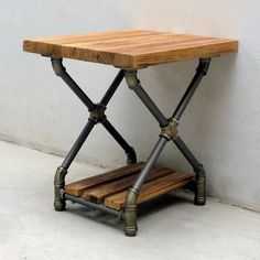 a small wooden table with metal legs and a shelf on the bottom that is made out of wood