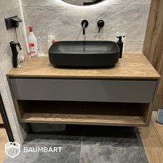 a bathroom with a sink, mirror and soap dispenser